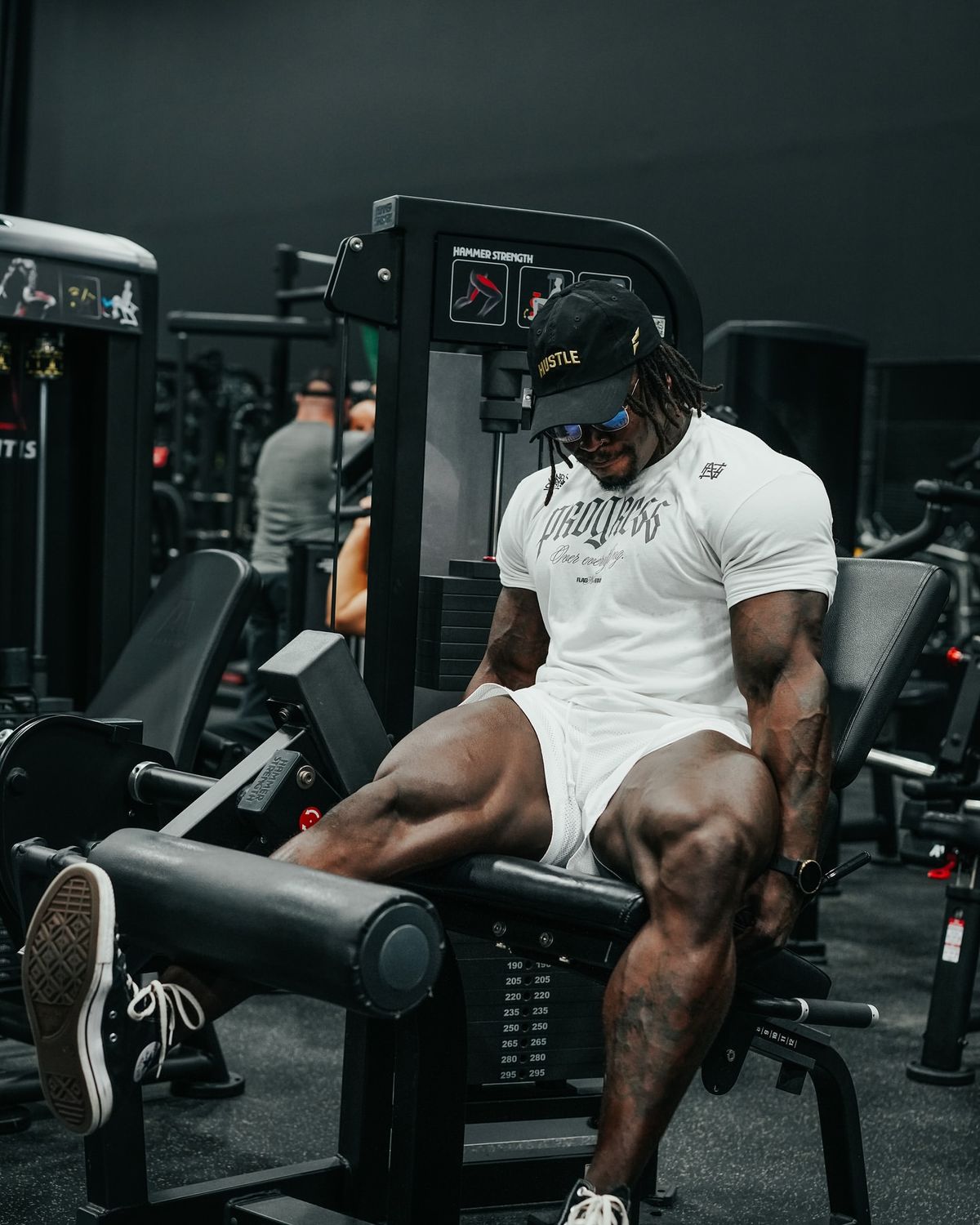 Athlete using a leg extension machine
